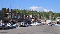 a row of parked cars on a street in a small town